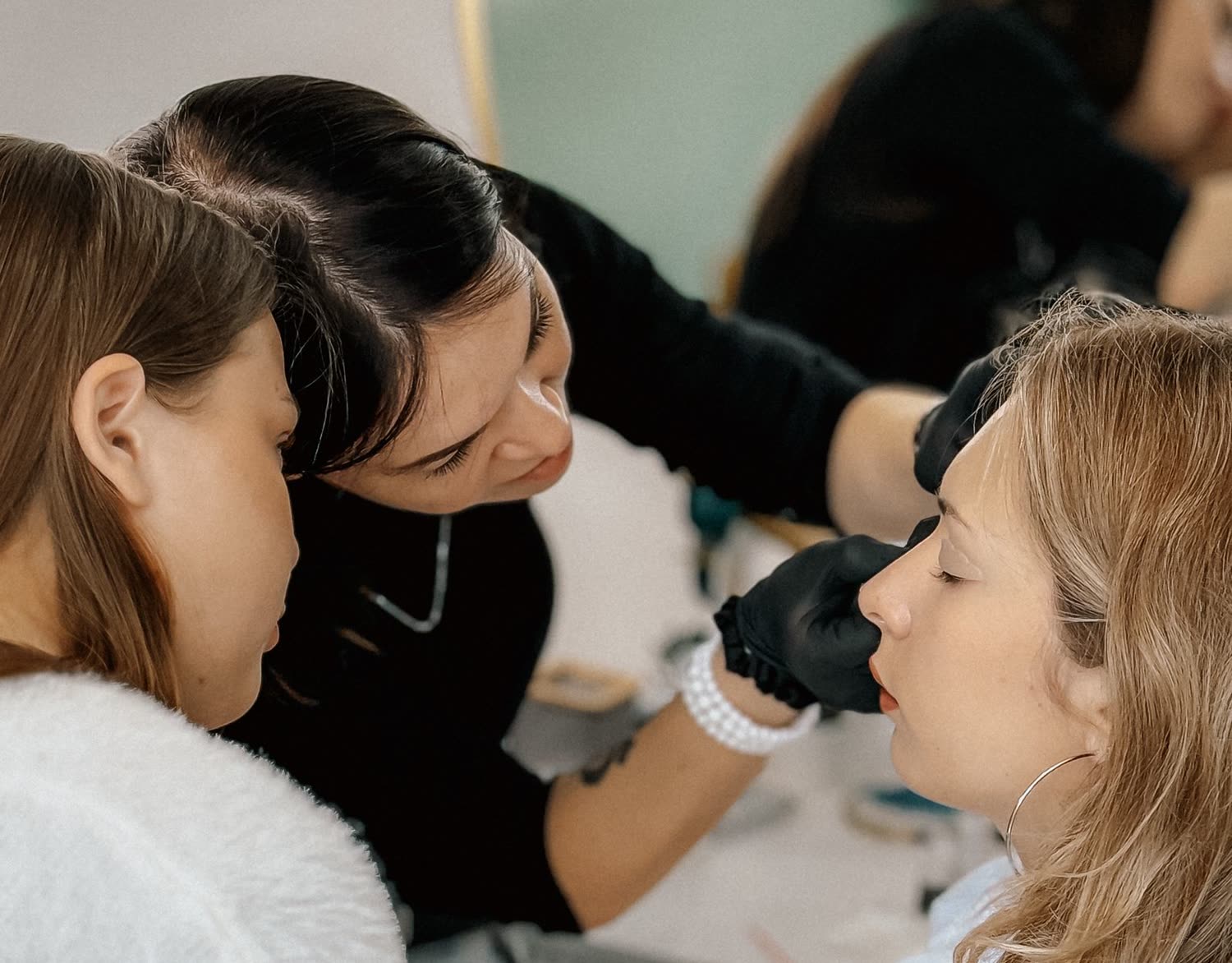 An instructor demonstrating a treatment technique to a trainee at the House of Oceanus Academy